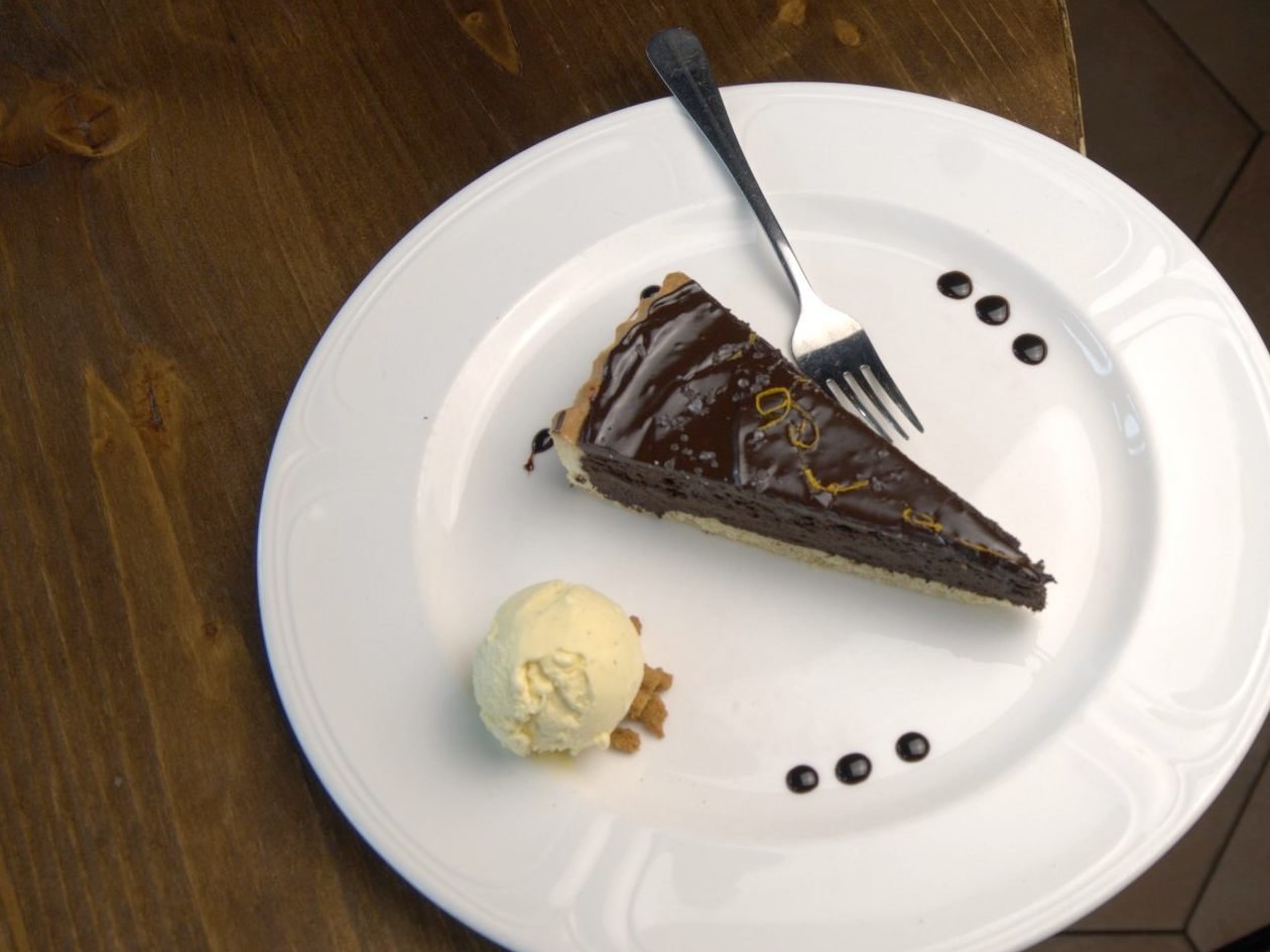 Dark chocolate tart with orange zest and sea salt, served with vanilla ice cream